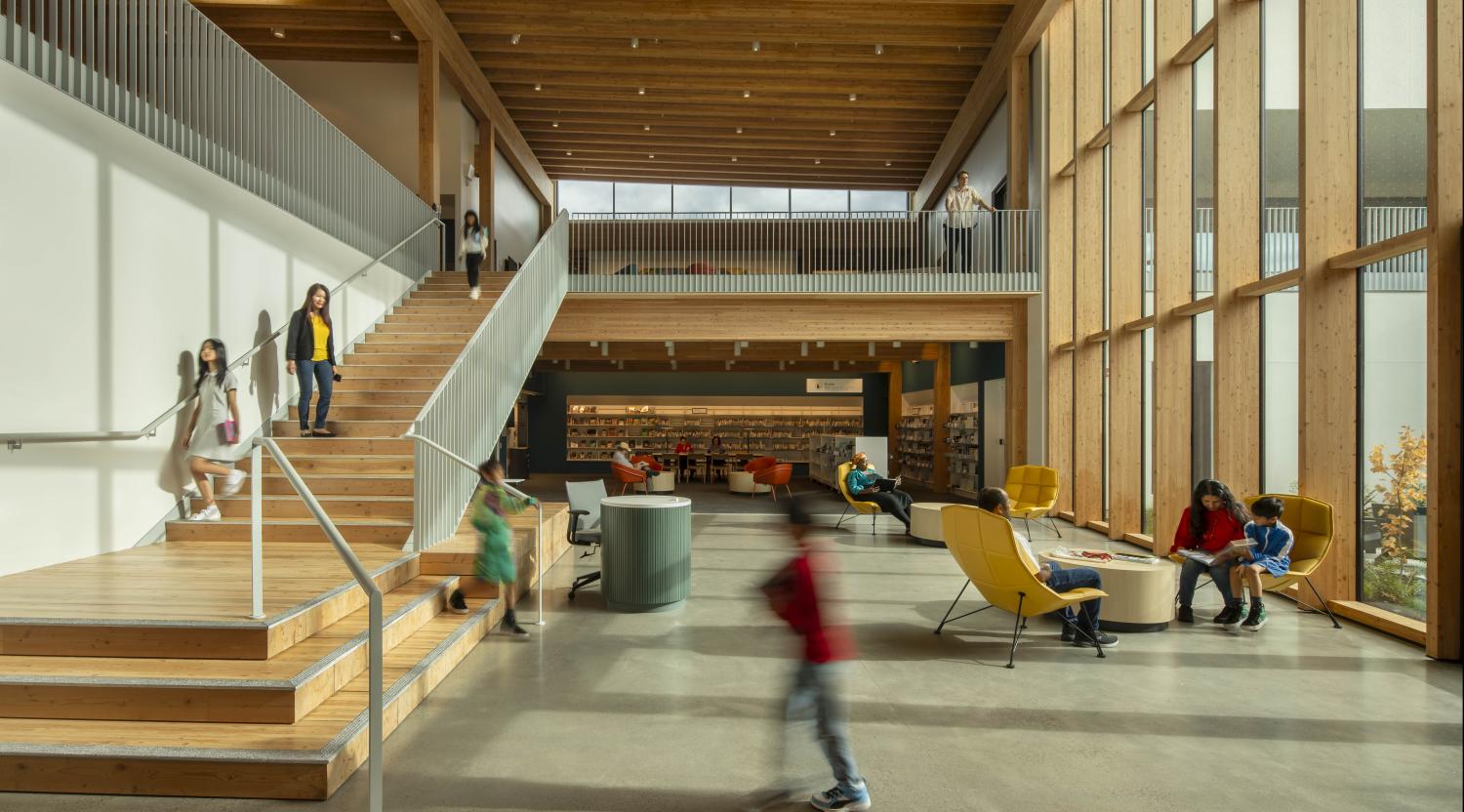 Albina Library interior featuring a 2-story community room with floor to ceiling windows in Portland, OR