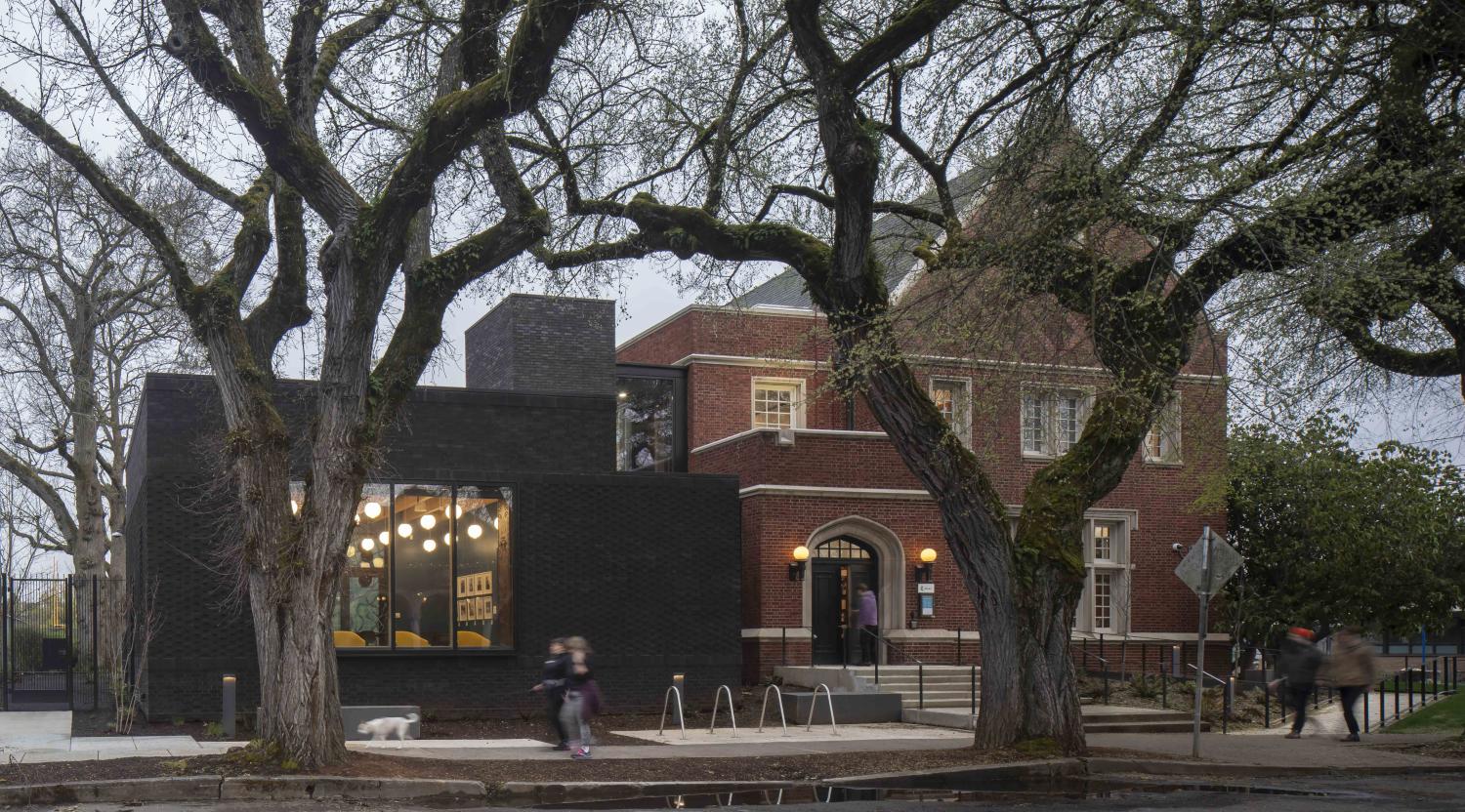 North Portland Library renovated and expanded exterior with mature trees in Portland, OR