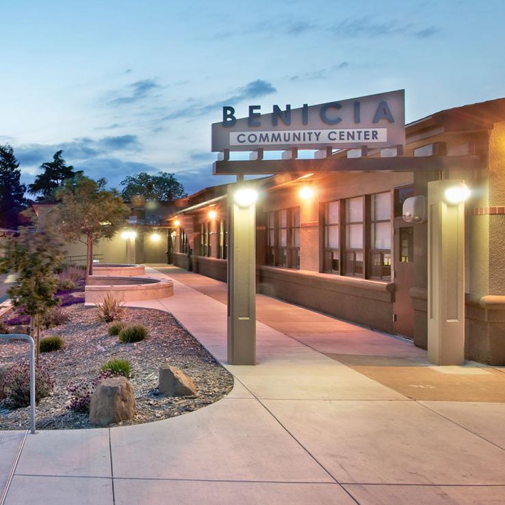Exterior view of main entry showing signage and landscaping